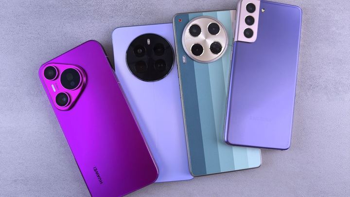Four modern smartphones lying side by side, showing their rear camera designs